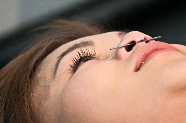 SF State's Nursing major, Ly Do, gets a nose pierceing at Mom's Body Shop on Haight street in San Francisco, April 21, 2012.