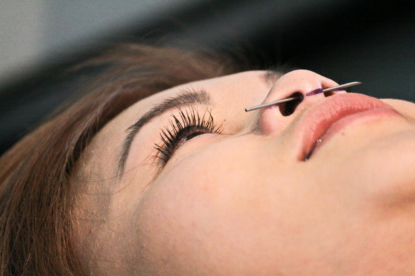 SF States Nursing major, Ly Do, gets a nose pierceing at Moms Body Shop on Haight street in San Francisco, April 21, 2012.