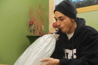 Medicinal marijuana patient, Kenneth Malone, 26, utilizes the vaporizer in a lounge at Igzactly 420, Dec. 17, 2012.