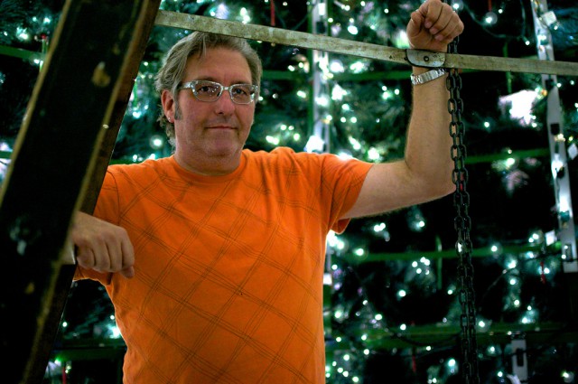 Edward Dahl stands in the center of the forty-foot-tall Barrango Christmas tree he and his team set up in Stonestown Galleria for the holiday. Photo by Kate ONeal / Xpress