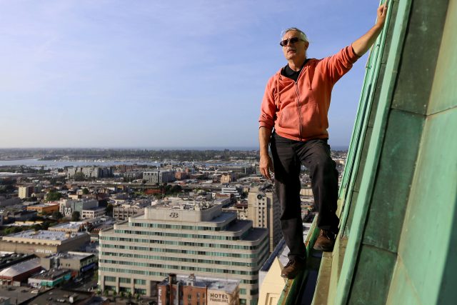 John Law demonstrates how he scales the Tribune Tower in orderto fix its LED lights on the outside in Oakland, Calif. on Thursday April 14, 2016. Law works at the tower, fixing its many clocks and their LED lights. This isnt part of  his usual urban exploring adventures but it does satisfy the thrill of doing something as exciting. (Aleah Fajardo/ Xpress)