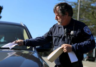 Bill Kettle writes parking tickets for cars violating the street sweeping signs in San Francisco on Monday April 25, 2016. (Aleah Fajardo/ Xpress)