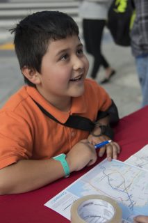 Josue Bonilla draws his ideal routes to Civic Center from few different locations on the map at the SFMTA booth at SE corner of Mission Street and silver Avenue on Wednesday, Aug. 31, 2016.