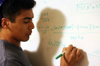 GSP Student Ivan Manriquez works on an equation for his calculus class in his dorm at the Towers dormitory on Tuesday, Oct.18, 2016. Manriquez hopes to gain a degree in astronomy from SFSU with the help of the Guardian Scholars program.