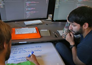 Hack Reactor students Daniel Shneyder (right) and Nick Lathen (left) work together to figure out a software issue at Hack Reactor in San Francisco, Calif. on Oct. 6, 2016. Hack Reactor is an intensive 12-week software programing course which boasts a 98 percent graduate hiring rate. (George Morin/Xpress)