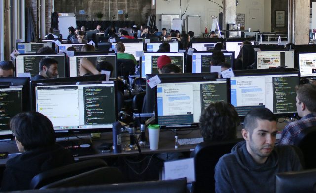 Hack Reactor students fill the eighth floor of Hack Reactor in San Francisco, Calif. on Oct. 6, 2016. Hack Reactor is an intensive 12-week software programing course which boasts a 98 percent graduate hiring rate. (George Morin/Xpress)