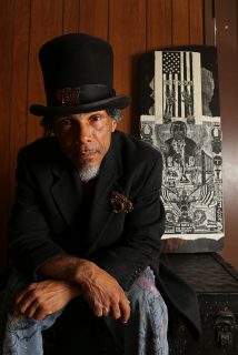 Ronnie Goodman sits with his chest, Serendipity, and one of his art pieces at the Redstone Building. Ronnie inherited Serendipity while up keeping the Redstone Building and uses it to carry his art/supplies when he goes out to sell his work. Aleah Fajardo/ Xpress