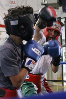 Saul Soto, 16, spars with Miguel Rosas, 11, at Fire in The Ring Boxing Gym. Connor Hunt // Xpress Magazine