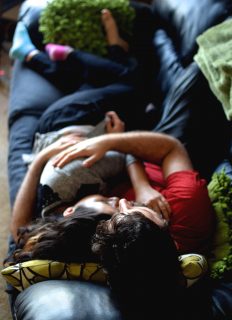 Yoni Alkan and Rosalie Del Toro cuddle on the couch inside of Alkan's private cuddle space. Alkan is a professional cuddler and offers non-sexual and therapeutic cuddle sessions. (Eric Chan / Xpress)