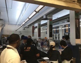 GLIDE's kitchen staff prepares to serve lunch to the community. The kitchen operates on volunteer power. (Lauren Grace Morris / Xpress)