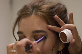 Avalon Petersen stands still as the make-up artist touches up her eyeshadow. Brenna Cruz/Xpress