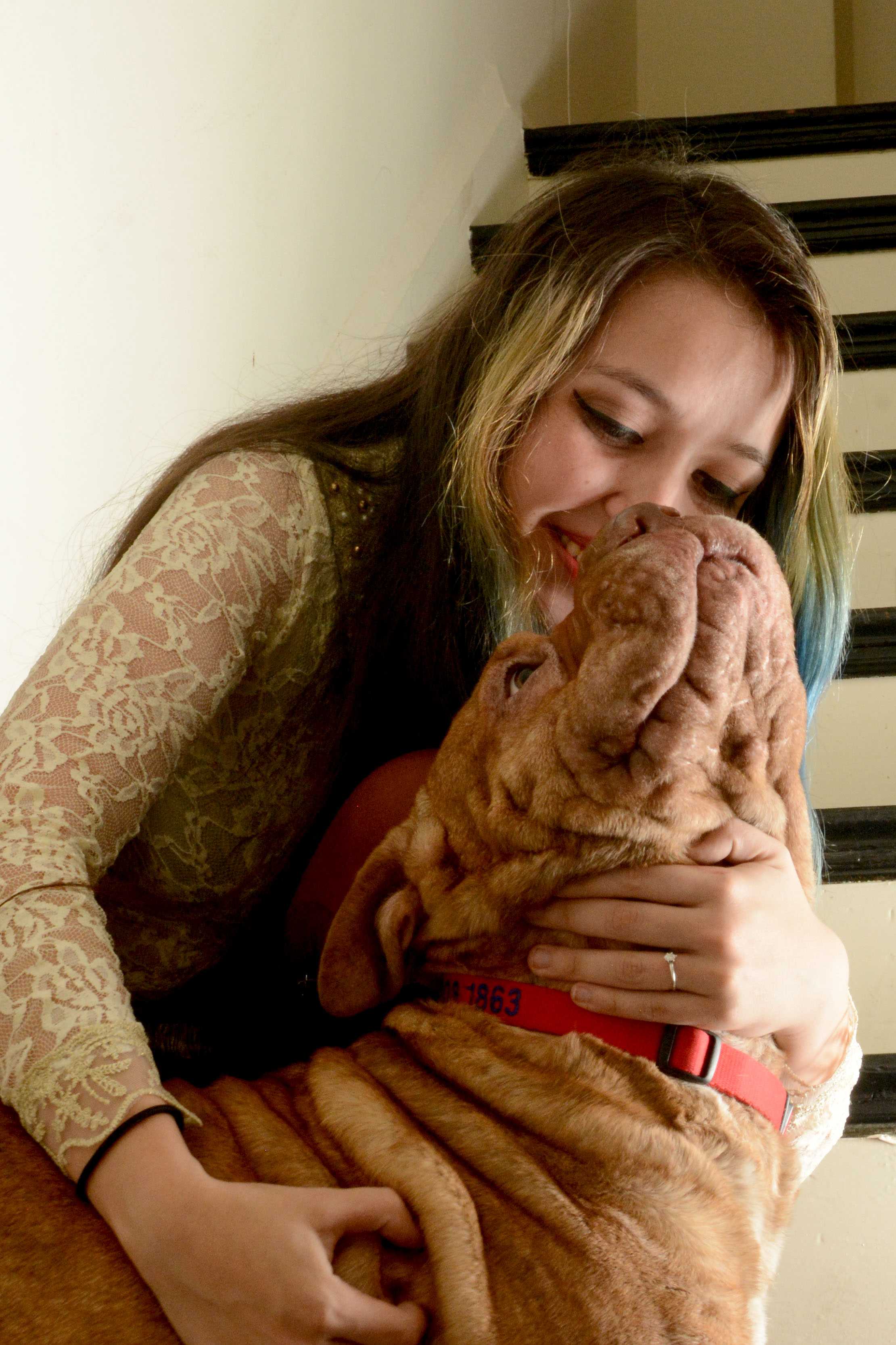 Pamela Ortiz plays with her dog, Zelda, in her San Francisco home. Photo by Aaron Levy-Wolins. 