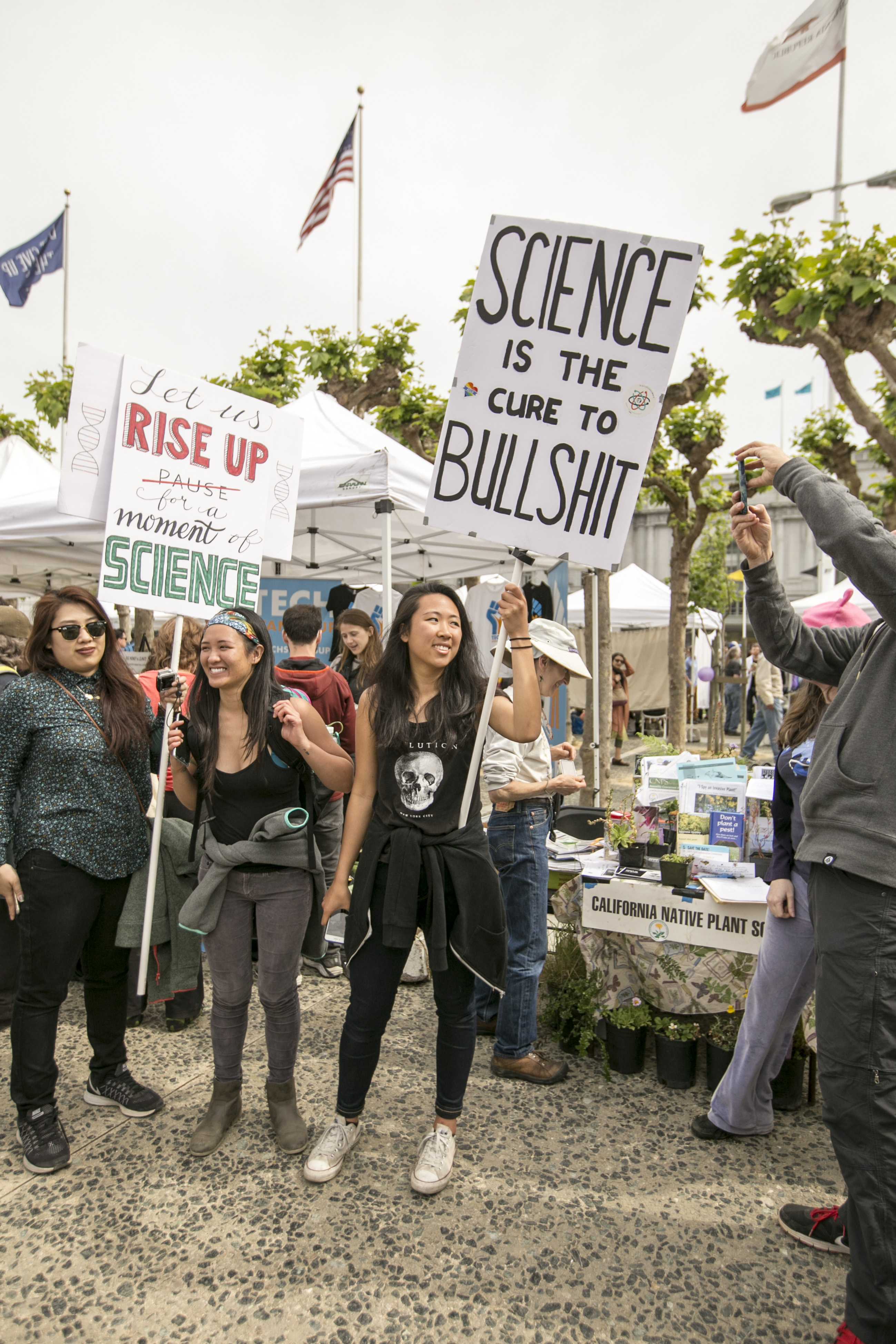 Megan Nguyen (center) Ana Reynoso (right) UC Davis students hold up signs during the March for Science at the Civic Center Downtown San Francisco on Sunday Apr. 23, 2017. (Ryan Zaragoza  Xpress).