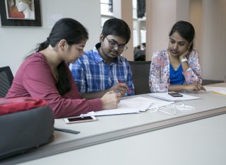 Priyanka Salvi (left) Sairoop Dasaraju (center) Bhavana Yadav (right) collaborate on an Industrial finances assignement at J. Paul Leonard Library at SF State on Apr. 16, 2017. (Ryan Zaragoza / Xpress).
