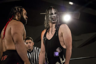 Jacob Fatu stares down -Jeckles the Jester- at APW_s Halloween Hell