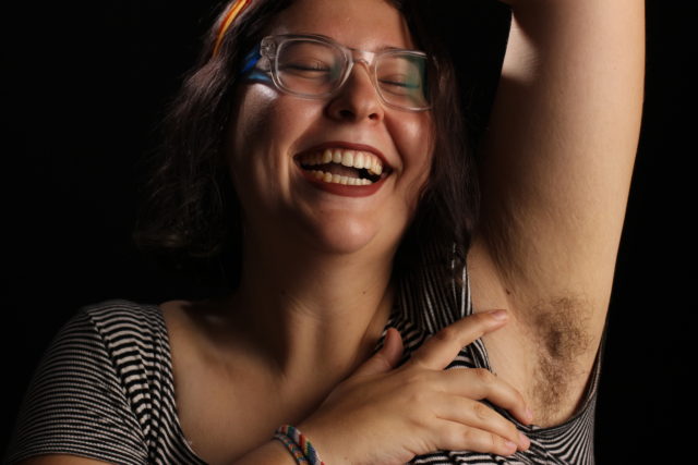 Mel Green, 19, displays her armpit hair. She first shaved her legs in elementary school to imitate her sister. As she grew older, she started pushing boundaries on femininity and a large part of that was putting down the razor. (Francisca Velasco/Xpress)