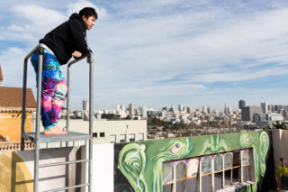 Bryan Steven Johnson Bradford, one of the nearly two dozen artists residing at a former nunnery now known as the Convent Arts Collective, relaxes on the roof of the collective while discussing the perks of living at the Convent. The Convent is a two-story arts collective in San Francisco that is home to a variety of artists who explore their creativity through a multitude of mediums including drag queen clothing design which is Johnson Bradford's particular art form. (Niko LaBarbera/Xpress)