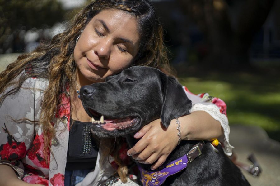 Daisy Soto cuddles her service dog, Miles in San Francisco, Calif. Feb. 26, 2020. (Emily Curiel / Xpress Magazine)
