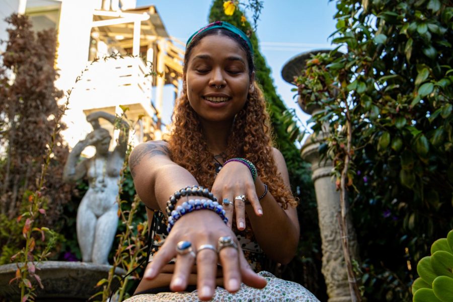 Gaia the Empress shows off her jewelry, which carries spiritual significance, in the garden of Sword and Rose, after purchasing new gemstones on October 14, 2020.