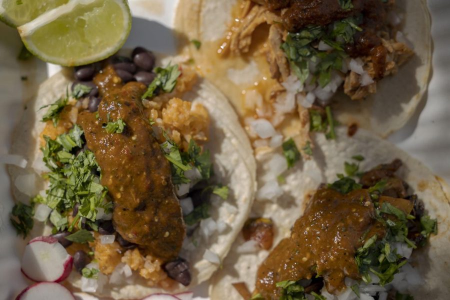 Three varieties of Molcaxitl tacos sit in a biodegradable plate along with two lime slices and sliced radishes, ready to be served at the Outer Sunset Farmers’ Market in San Francisco on Oct. 25, 2020. (Emily Curiel / Xpress Magazine)