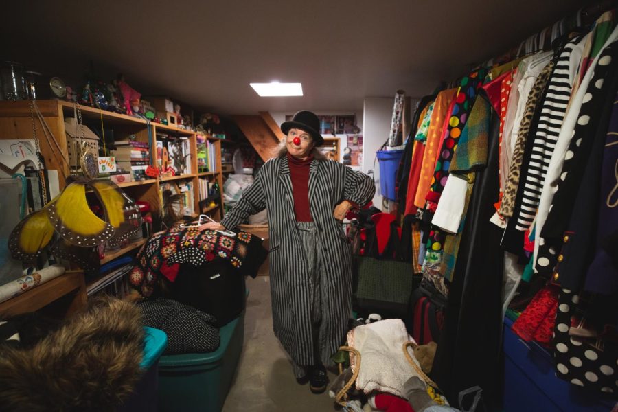 8645: Christina Lewis stands in the storage room in her basement that contains her life collection of clown costumes and memorabilia in San Francisco on Oct 27, 2021. (Saskia Hatvany / Xpress Magazine)