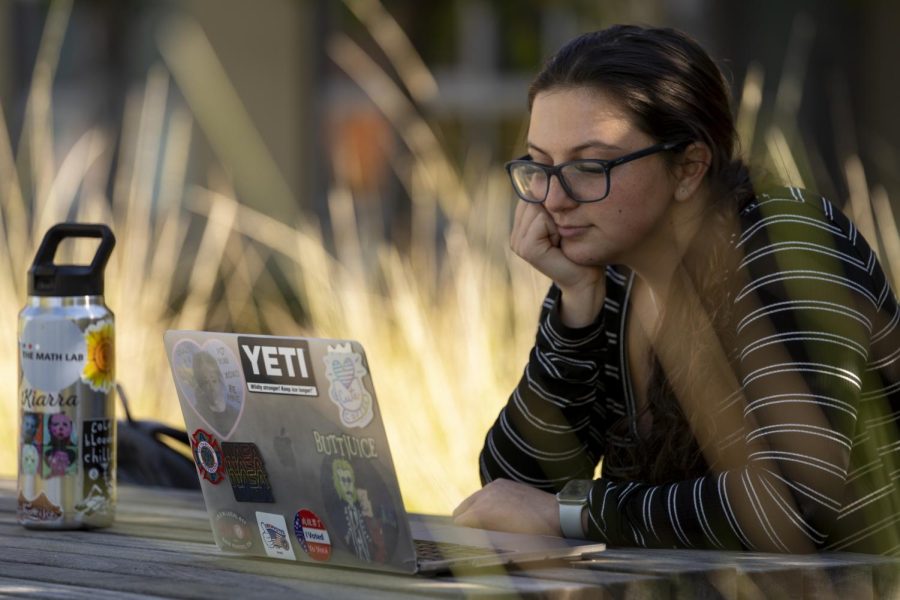 Kiarra Dolan watches a show on her laptop outside of her work in San Mateo, Calif., on Nov. 11, 2021. Dolan is a student at California State University East Bay who enjoys true crime mysteries in her downtime. (Nicolas Cholula / Xpress Magazine)