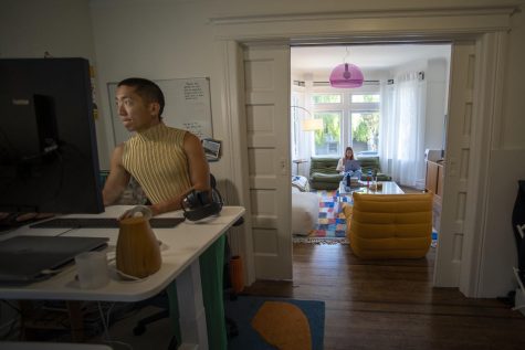 Sophia Hu and her boyfriend work from their home in the Inner Sunset in San Francisco, Calif., on Dec. 7, 2021. Hu sits in her living room while her boyfriend works at his desk. (Nicolas Cholula / Xpress Magazine)