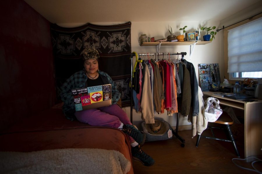 Vick Montaño logs in to their laptop from bed in Oakland on March 10, 2022. Montaño is a Two Spirit Yaqui and Mexica, also spelled Mexikah, designer and activist born and raised in Oakland. (Nicolas Cholula / Xpress Magazine)