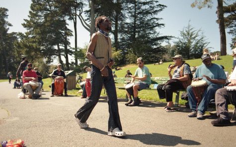Larry Miles struts in the middle of the Hippie Hill drum circle on April 9, 2022. Miles is a regular to the drum circle and often sings and dances in the concrete pathway. (Maximo Vazquez / Xpress Magazine)