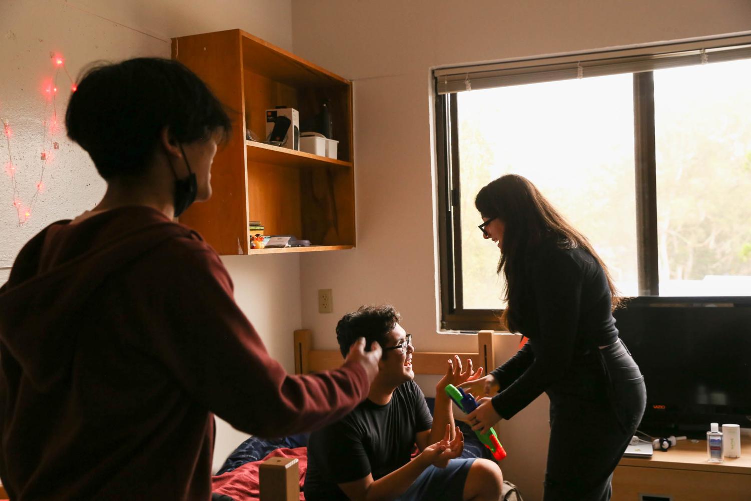 First-year student Christian Aransazo (left), Oscar Duran (center) and Elisa Hanhan (right) hang out in Duran’s dorm in Mary Park Hall at SF State on Monday, Sept. 12, 2022. Aransazo and Hanhan both commute, so Duran’s dorm is a place to hang out on campus. (Juliana Yamada/Xpress Magazine)