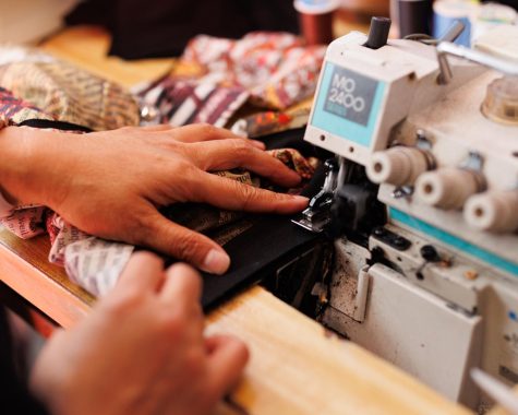 Ivy Chan sews into a gray shirt that will be later upcycled into a new set of clothing. They will later be sold in ISSO in the Mission at 3608 19th St. (Abraham Fuentes / Xpress)

