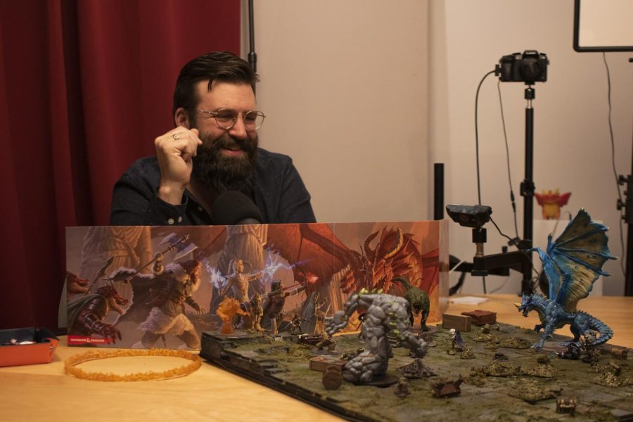 Devon Chulick, game master for “Total Party Chill,” behind his DM screen recounting the party’s previous battle on November 29th, 2022. One player was polymorphed into a dinosaur while another was downed fighting in a dragon’s lair. (Oliver Michelsen / Xpress Magazine)
