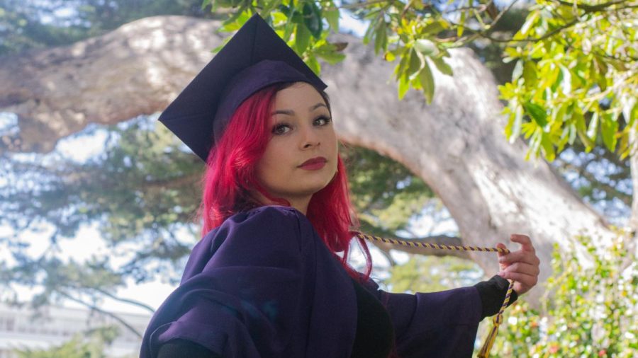 Tanya Ochoa demonstrates one of SF States best spots to take graduation photos: the Quad. (Daniel Hernandez / Xpress Magazine)