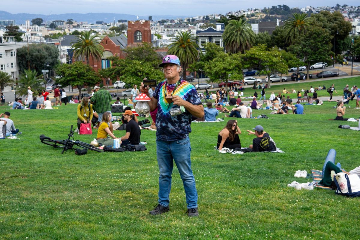 TD Triple OG, the original, he calls himself, poses for a photo with his various items he
sells at Dolores Park in San Francisco, California on September 2, 2023. (Ryo Kojima/Xpress Magazine)