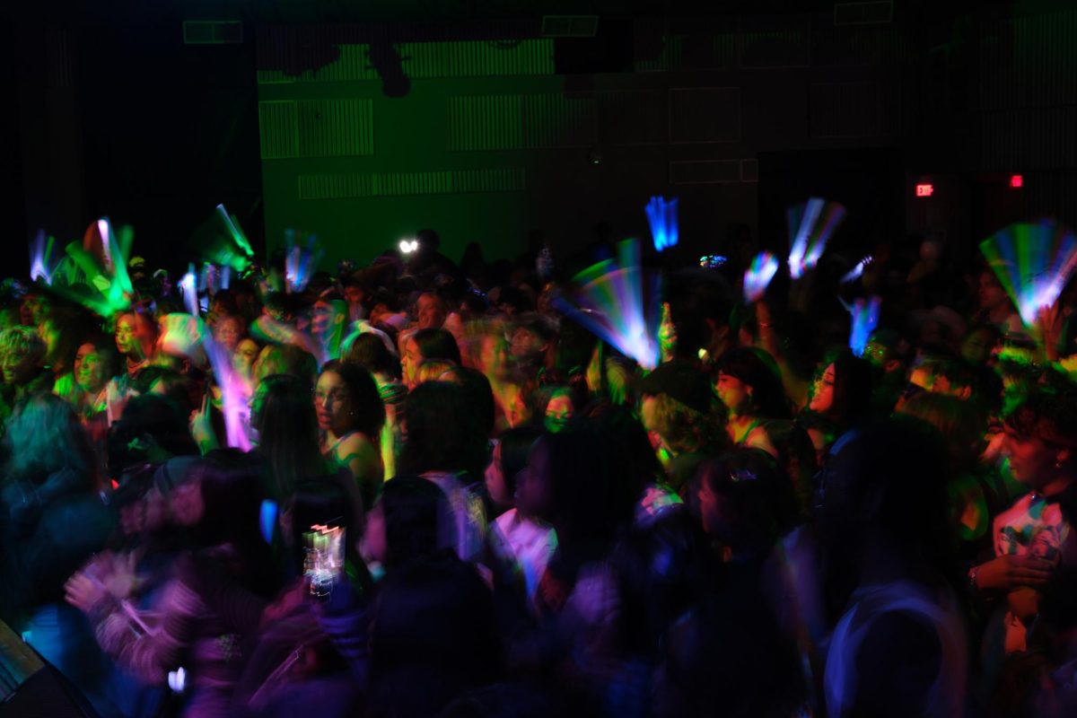 A crowd waves glow sticks during DJ Mandy’s set at the KSFS @ Jack Adams Hall Halloween show, which was co-hosted by The Depot, on Thursday, Oct. 26, 2023. (Andrew Fogel/Xpress Magazine)  