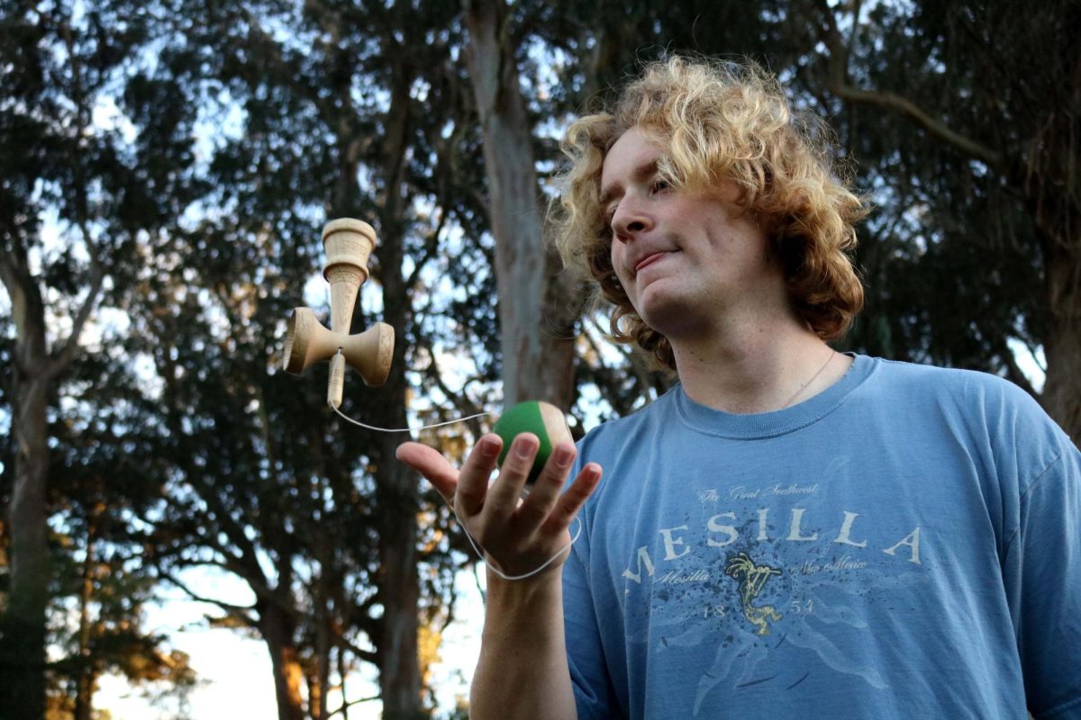 Tobias Roat practicing kendama tricks in Golden Gate Park.