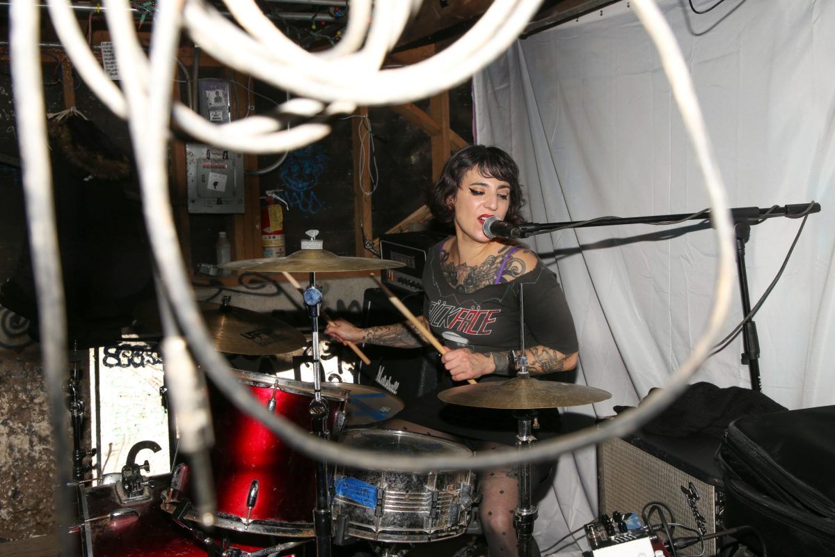 The drummer of the X-Tra band shouts into the microphone as she drums at Thrillhouse
Records on December 2, 2023 in San Francisco, Ca. (Tam Vu / Xpress Magazine)