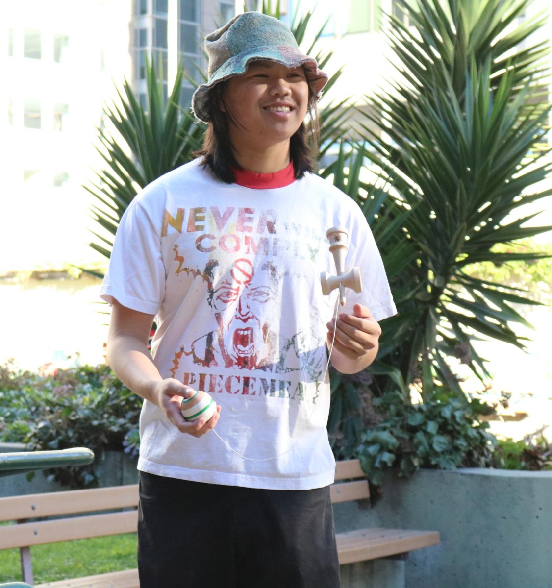 Vincent Ho holds his kendama in Mary Square Park