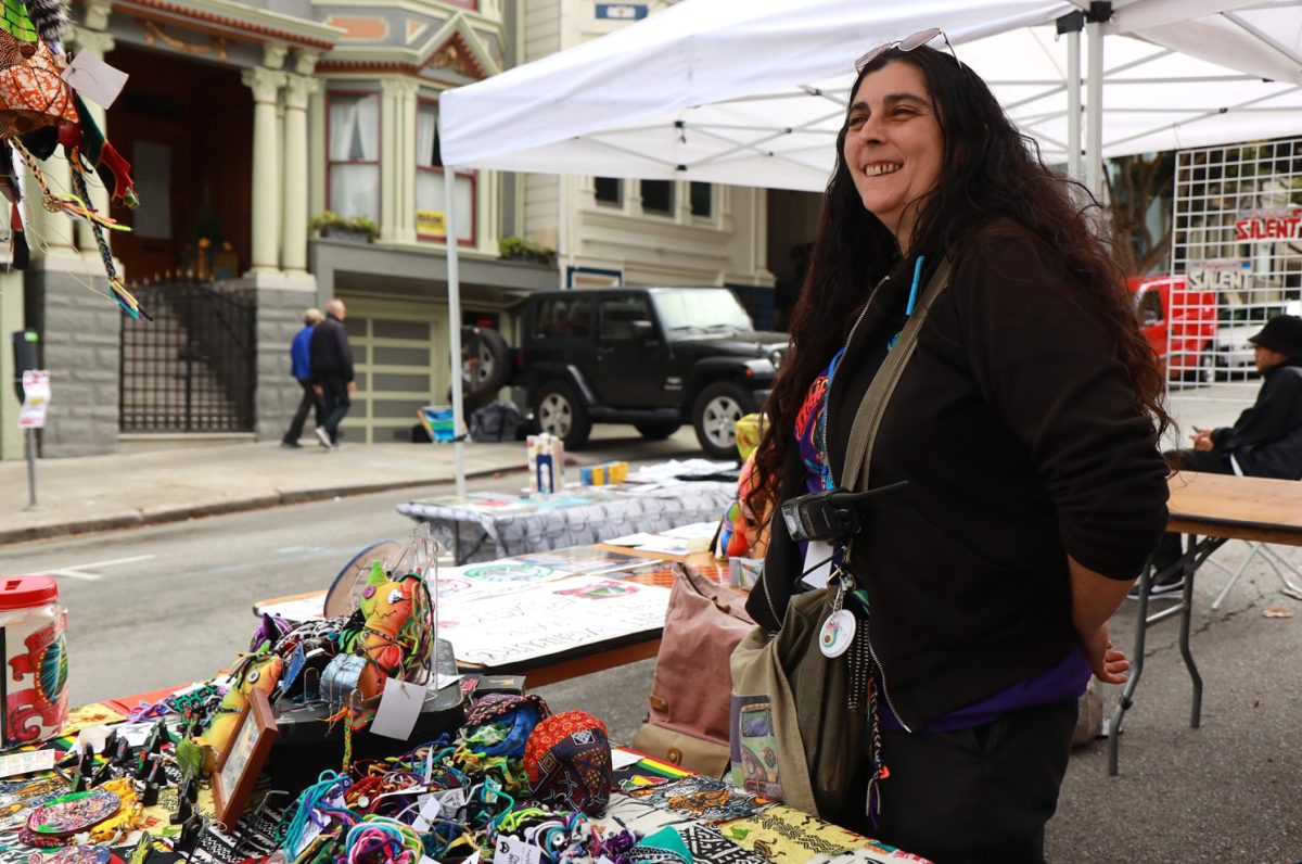 Andrea Fuenzalida stands at her table at the Haight Ashbury Street Fair Art Walk in San Francisco, Calif., on Sunday, Sept. 15, 2024. (Braelyn Furse / Xpress Magazine)