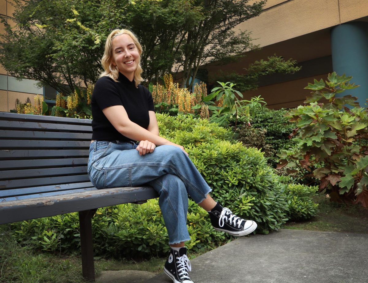 Ava Austin, 21, of San Francisco, Calif., seated in front of the Humanities building at San Francisco State University in San Francisco, Calif., on Tuesday, September 10, 2024. Austin studied linguistics in the Humanities building, receiving their Bachelor’s degree in 2024. (Jonah Chambliss Xpress Magazine) 