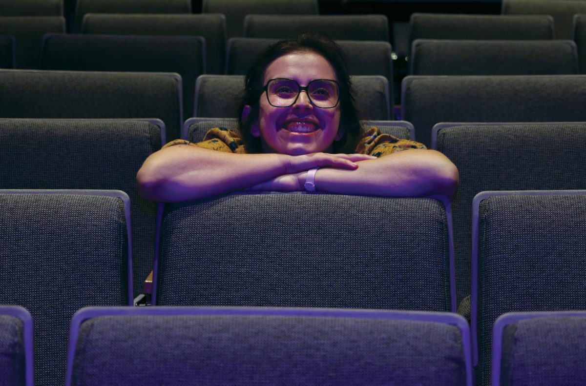 Alexandra Balistreri, President of the Delta Kappa, looks up towards the colorful screen Coppola Theatre at San Francisco State on Sept. 30, 2024. (Gabriel Carver / Xpress)