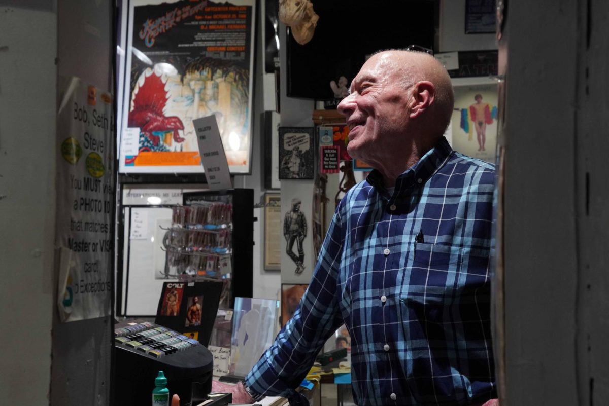 Patrick Batt works at the cash register of his store, Auto Erotica, in San Francisco, Calif. on Oct. 1, 2024. (Autumn DeGrazia/Xpress Magazine)