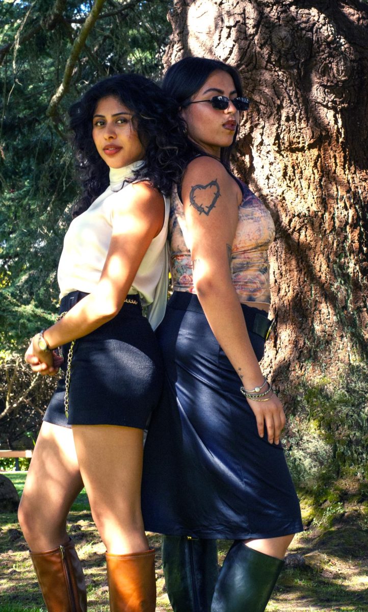 Angely Alas, left, and Alisa Martinez, right, pose at the Garden of Remembrance at SF State. (Rodliam Suspene / Xpress Magazine)