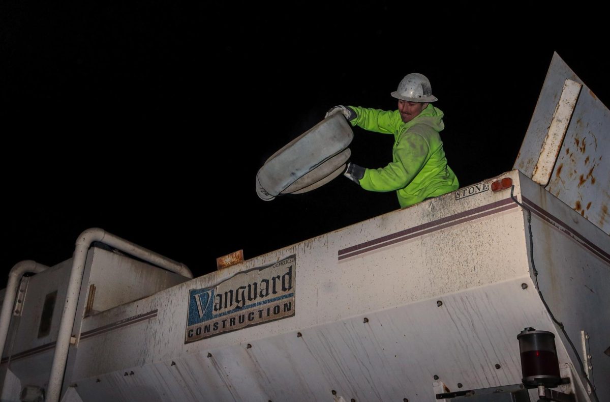 Austin Walden throws powder hoses out of the Volumetric plant bin
on Thursday, Sept. 12 in Lodi, CA. (Gabriel Carver / Xpress Magazine)  