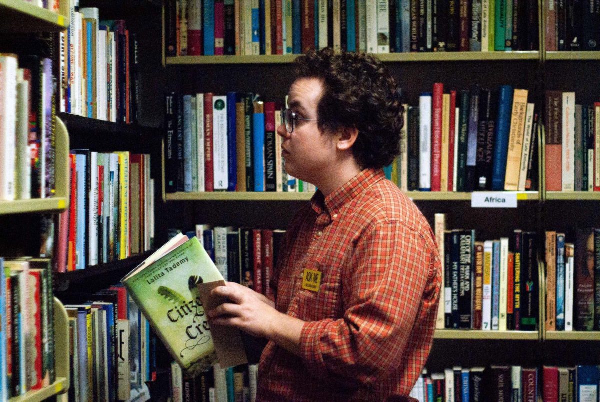 Elliott Scheuer, Library Services Specialist, browsing the Friends of the Library Bookstore at the J. Paul Leonard Library at SF State. (Rodliam Suspene / Xpress Magazine)