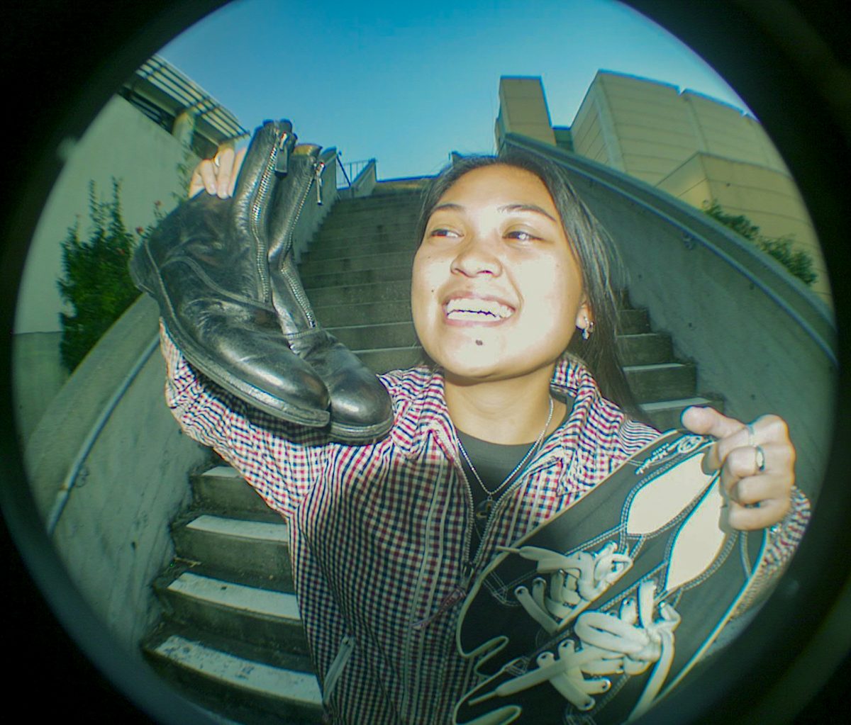 Clare Camasura, a sneaker enthusiast, poses at a staircase at Cesar Chavez Student Center at SF State. (Rodliam Suspene/Xpress Magazine)