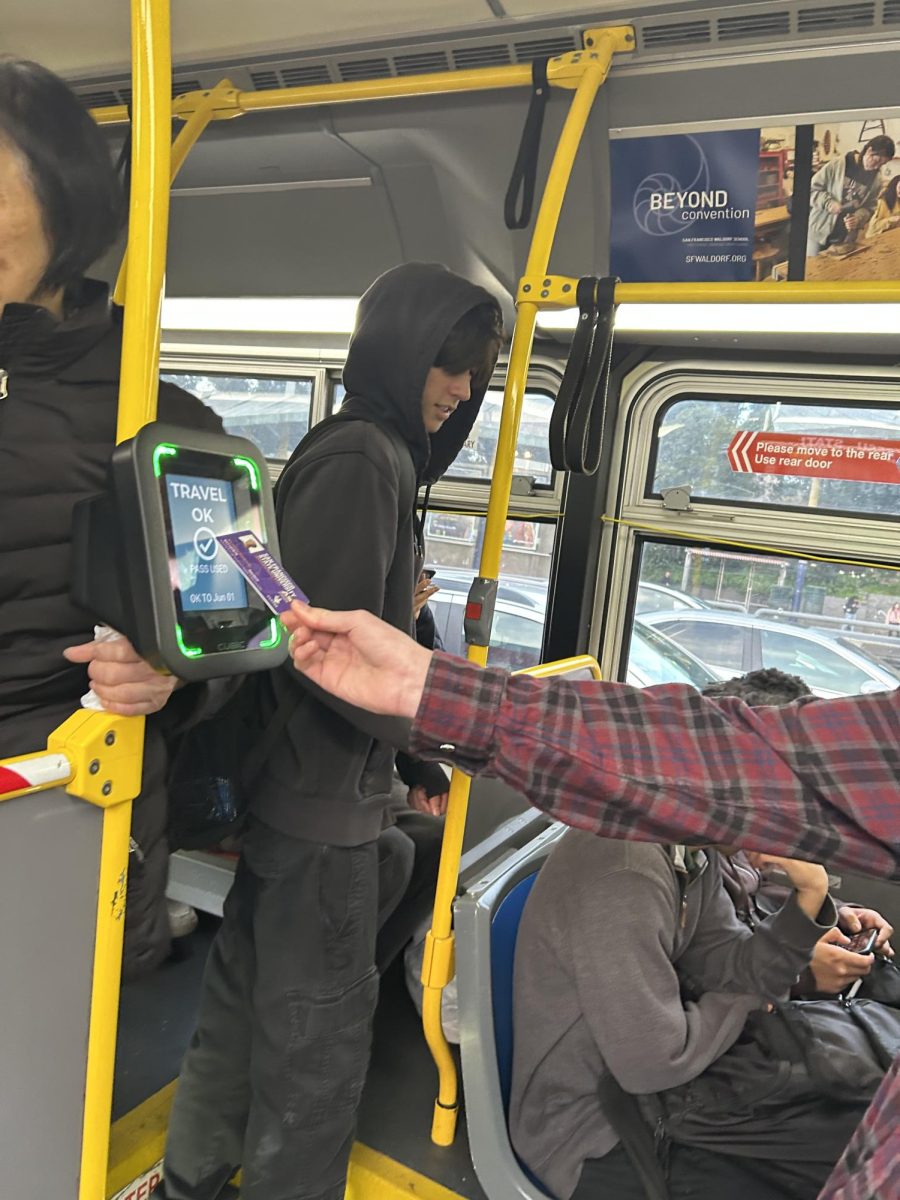 BECA student John Herzstein uses his OneCard at 19th & Holloway to board the 29 Sunset, a routine route for him. (Santiago Contreras / Xpress Magazine)