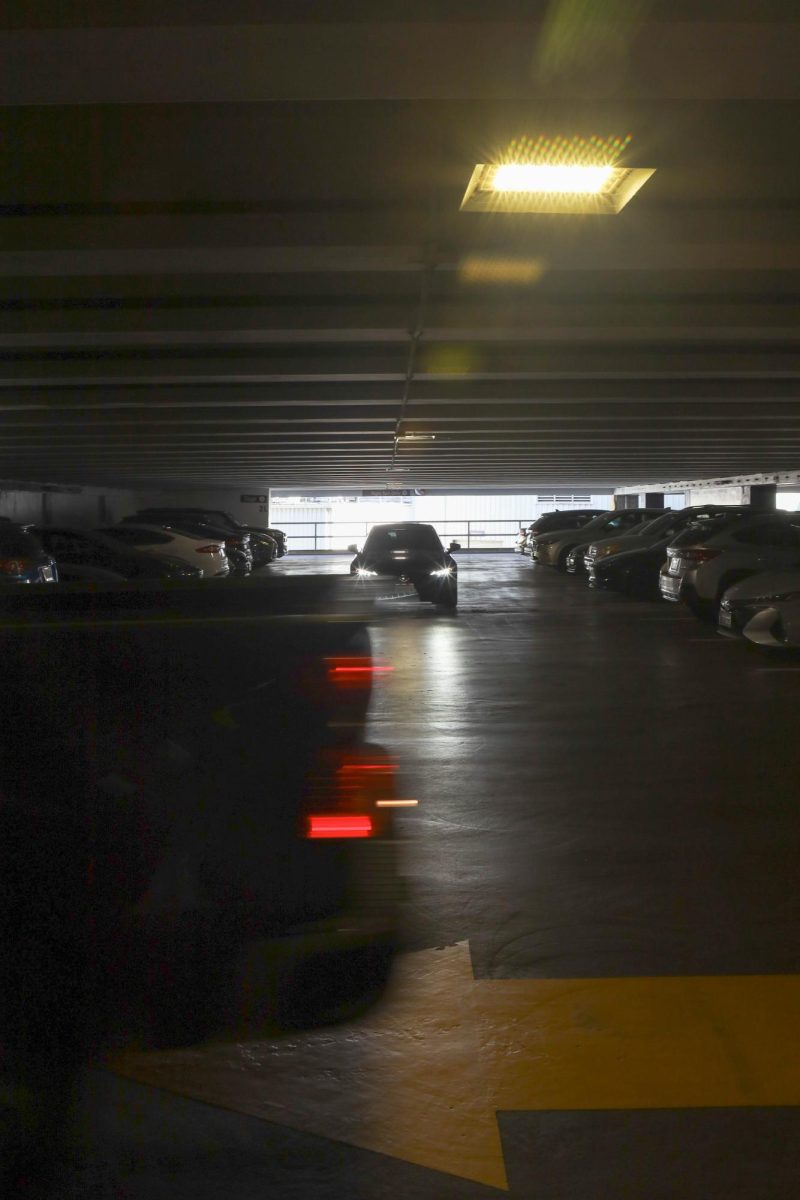 A truck zips by as another car approaches a parking spot in Lot 20. (Seamus Geoghegan / Xpress Magazine)