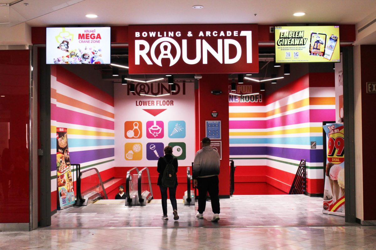 A pair of mall goers walks into Round 1 Bowling and Arcade located at the bottom floor of Stonestown Galleria. (Luke Cramer / Xpress Magazine)