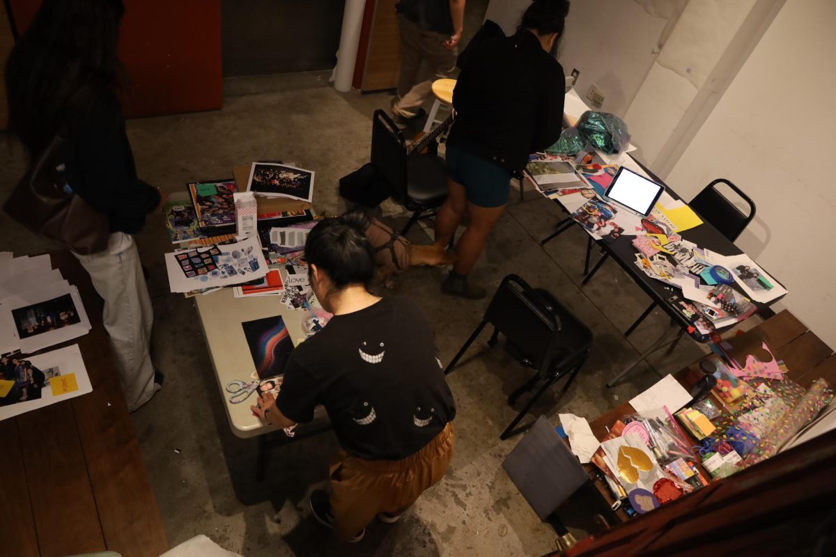 In celebration of their 25th iteration of the production, Joyce Yin and Sharleen Ignacio work on a visual arts timeline of "Stories High" performances from 1999 to 2024. (Angelique Persails / Xpress Magazine)
